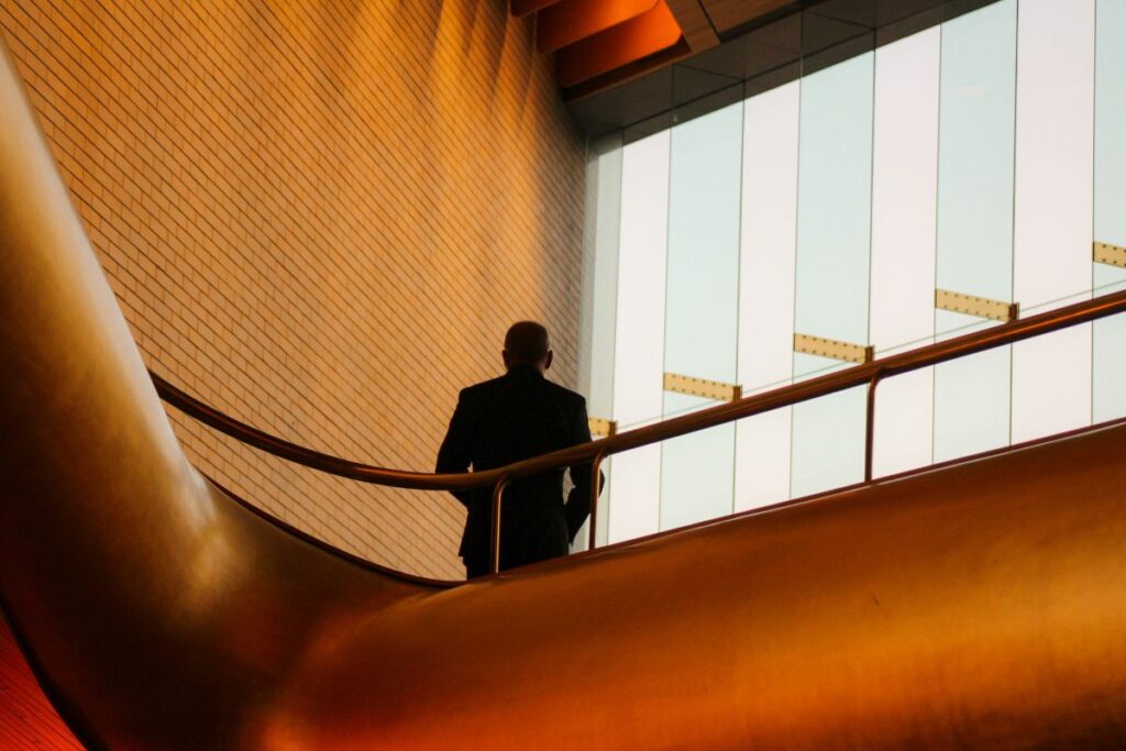 Silhouette of a man standing in an office building.