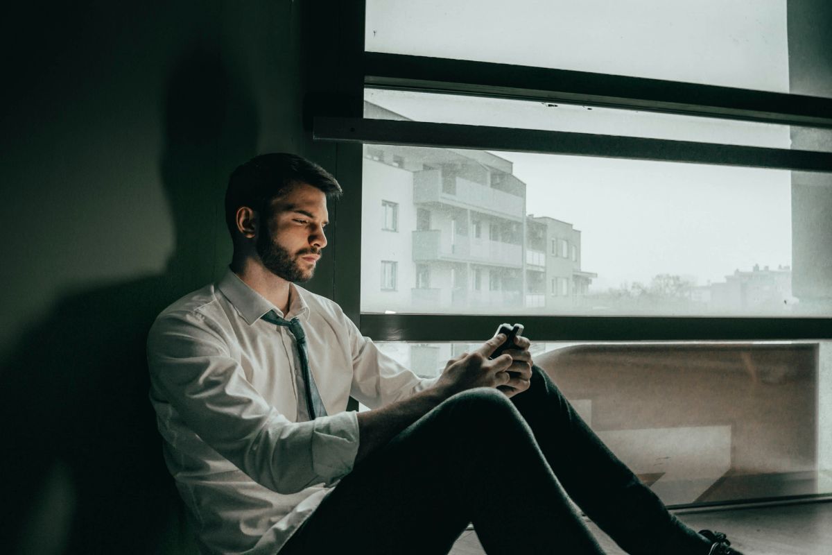 Sad man looking at his phone.